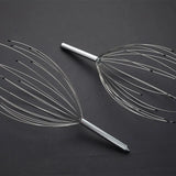 Metal massage tool on a dark background