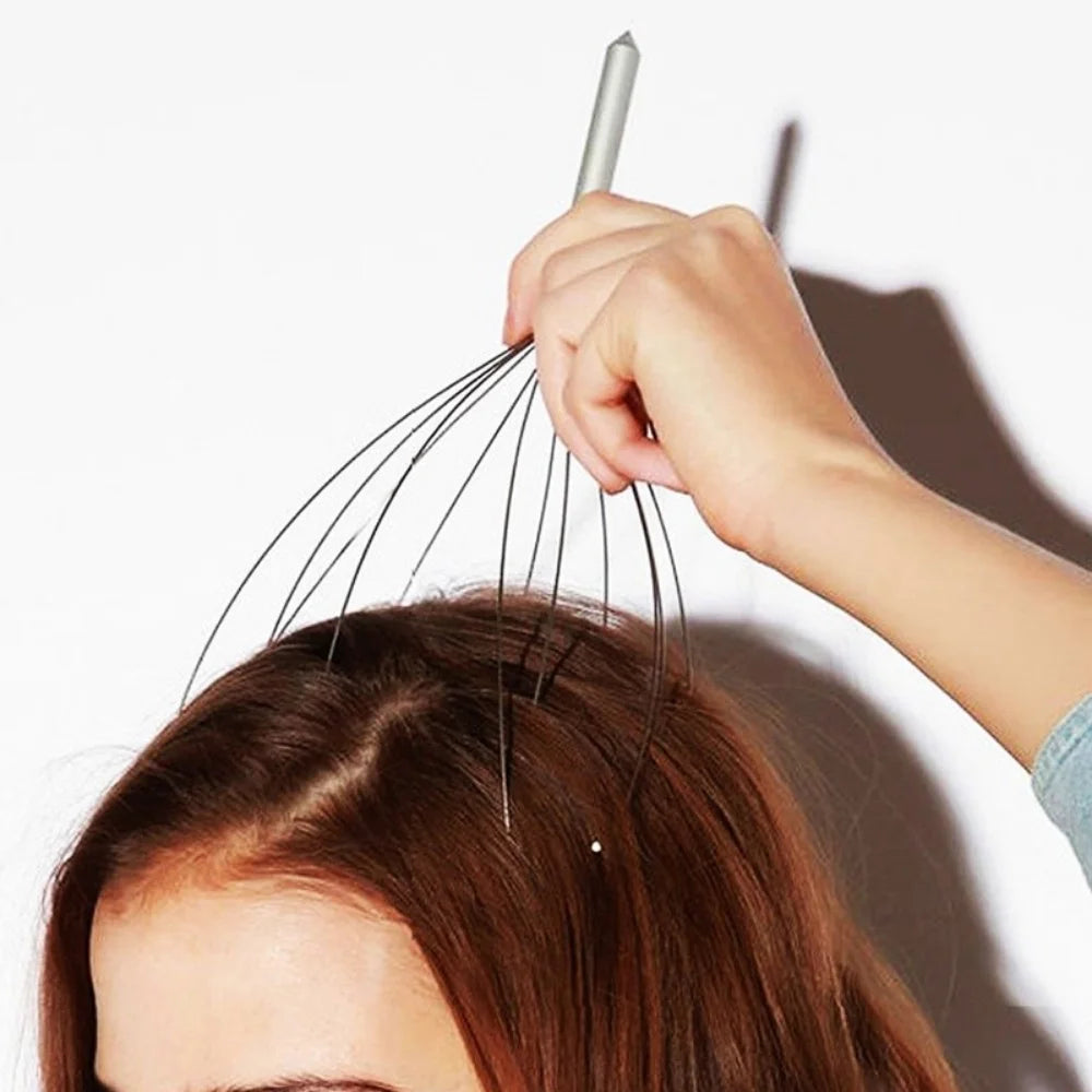 Person using a metal head massager on their hair against a white background