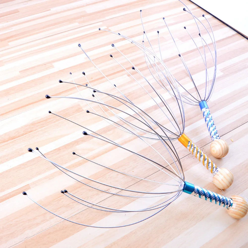 Massager tool with metal prongs on a wooden surface