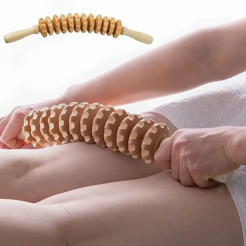 Person using a wooden massage roller on their leg with a plain background
